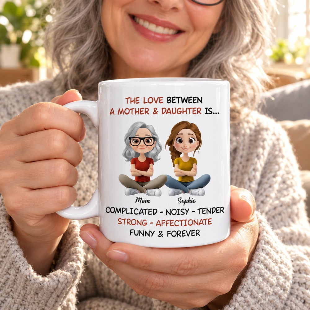 Mother holding steaming personalized mother and daughter mug in a bright living room