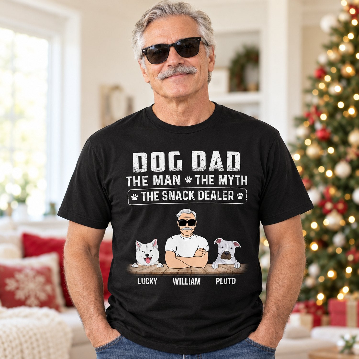 Man wearing personalized Dog Dad Snack Dealer black t-shirt in a bright holiday living room