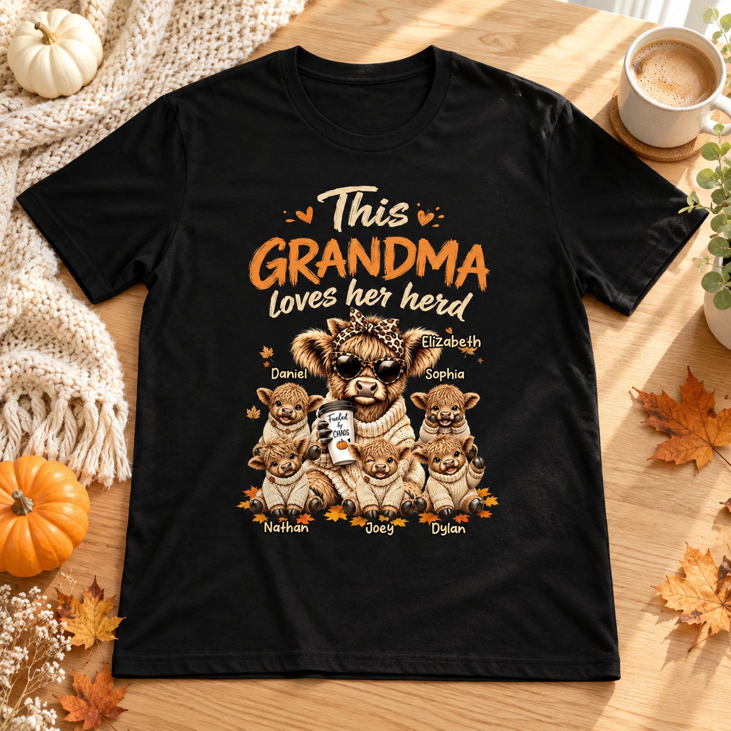 Personalized Grandma Loves Her Herd t-shirt flat lay with autumn pumpkins and cozy knit throw