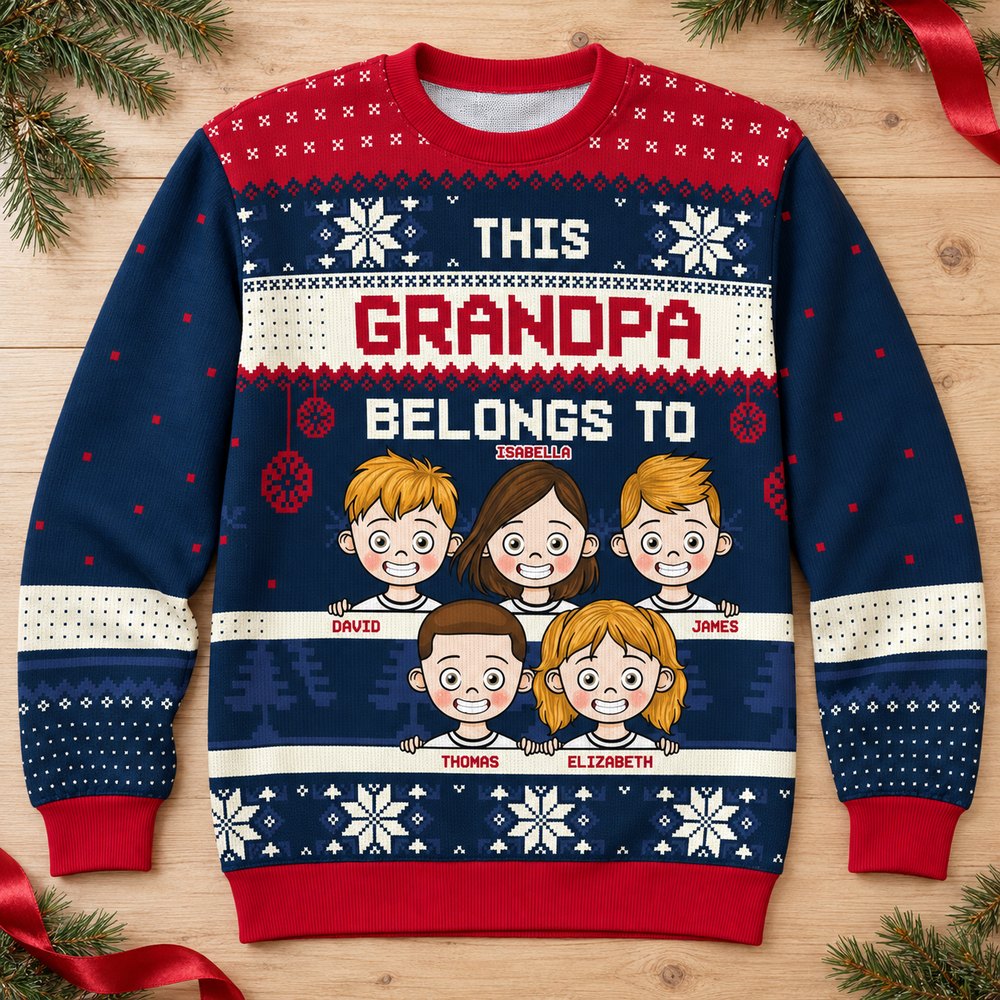 Personalized This Grandpa Belongs To ugly Christmas sweater flat lay with pine greenery