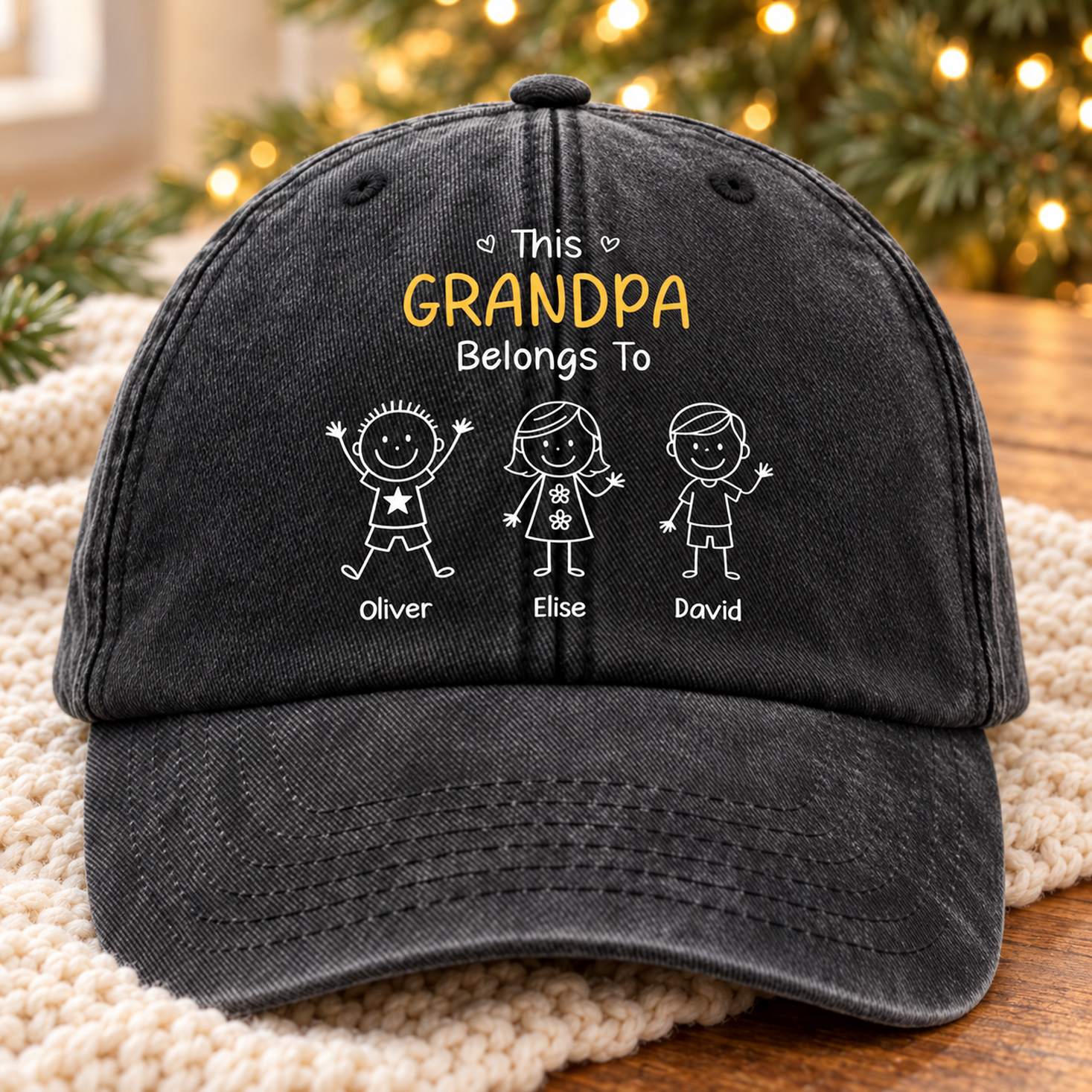 Personalized Grandpa washed denim cap on a knit throw with Christmas greenery in background