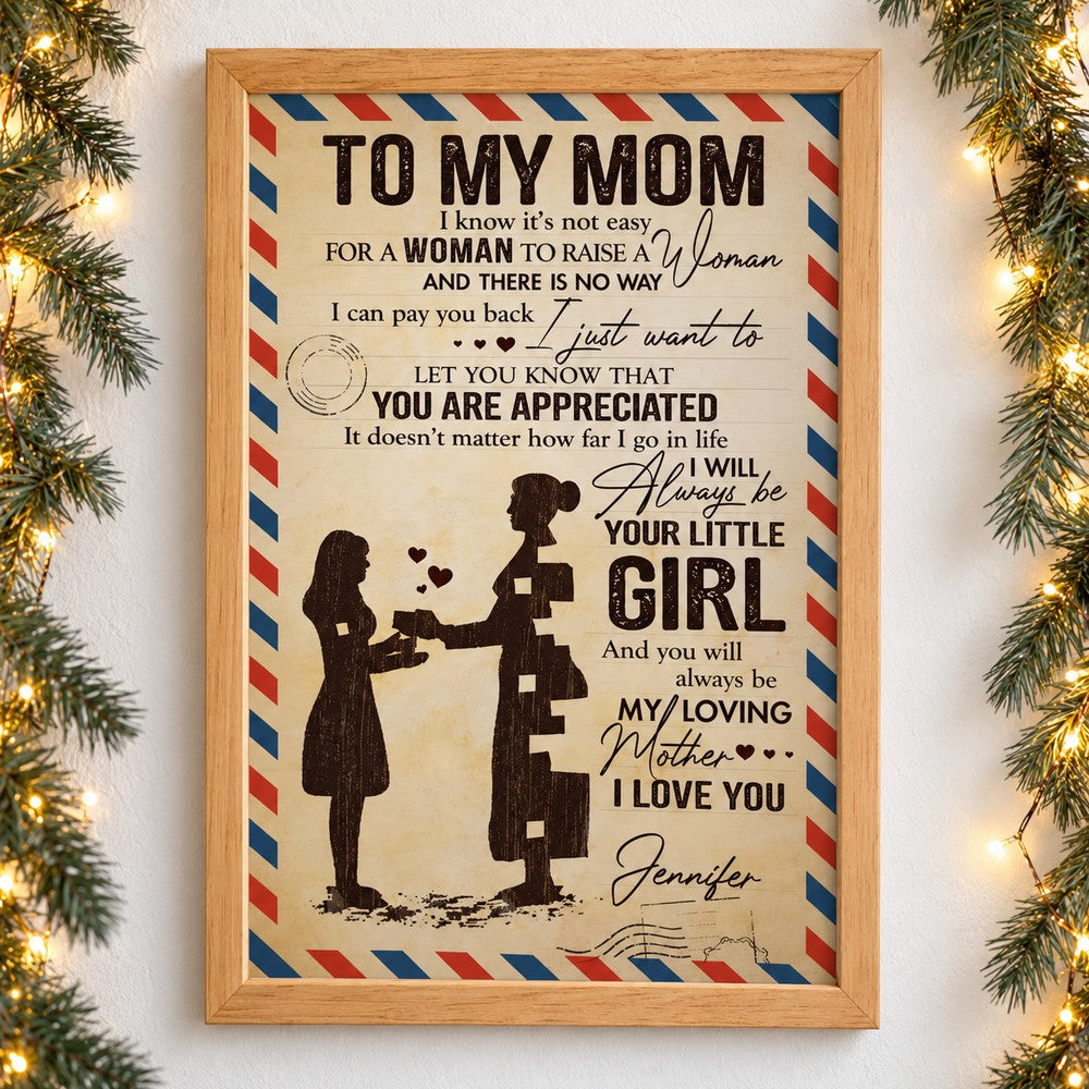 Personalized To My Mom framed poster hanging on a wall with Christmas garland and fairy lights