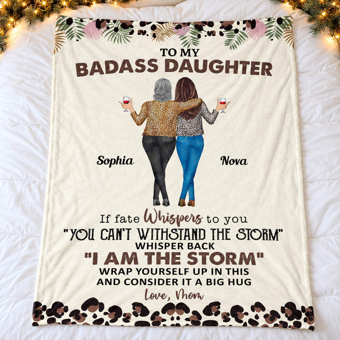 Personalized daughter blanket spread flat on a cozy bed with holiday garland