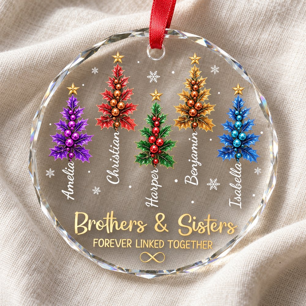 Close-up detail of beveled glass edge and colorful holly tree print on sibling ornament