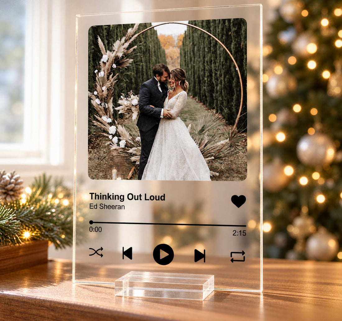 Custom photo song acrylic plaque standing on a holiday mantelpiece with blurred Christmas tree