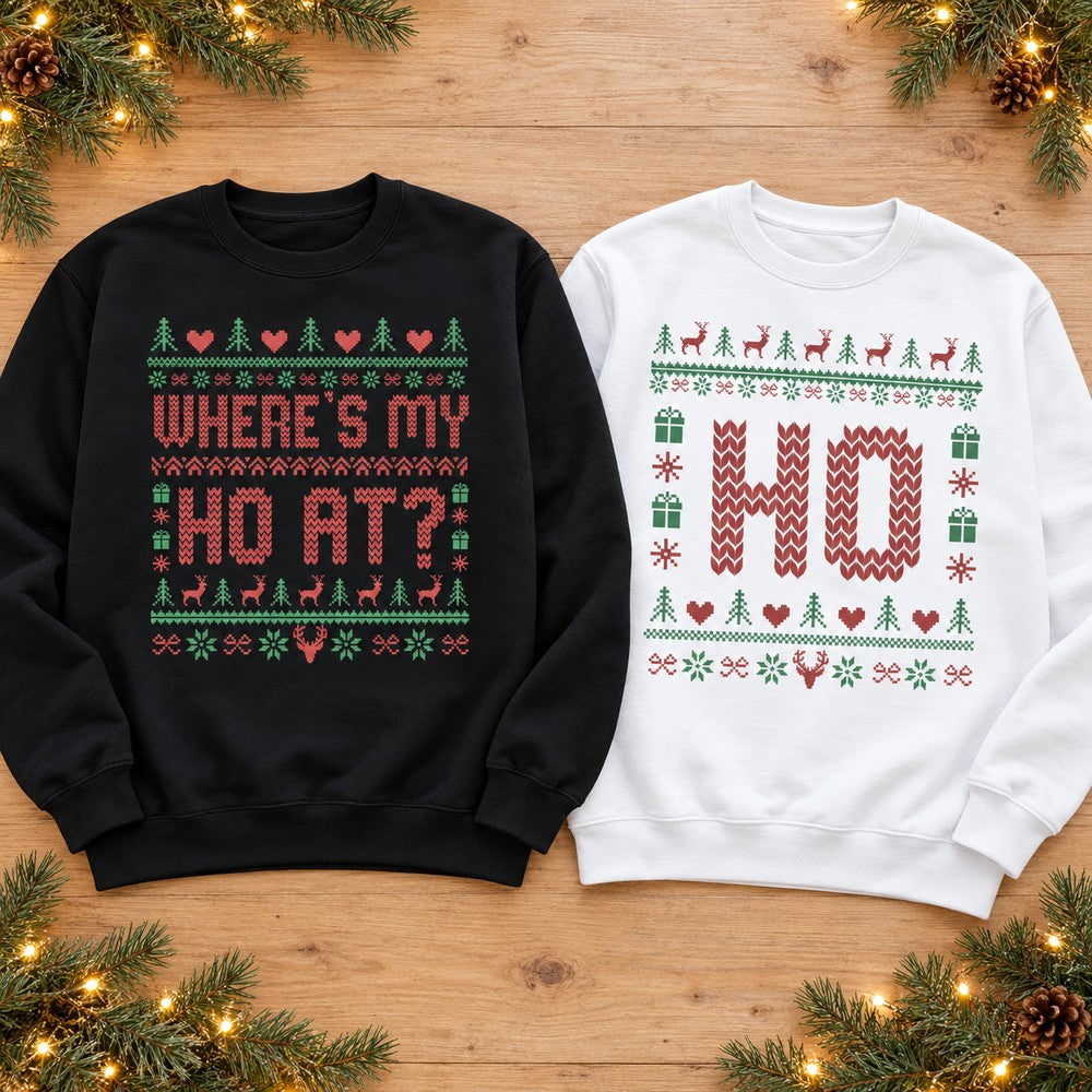 Forest green Wheres My Ho At sweatshirt and white Ho Christmas sweatshirt laid flat with pine greenery