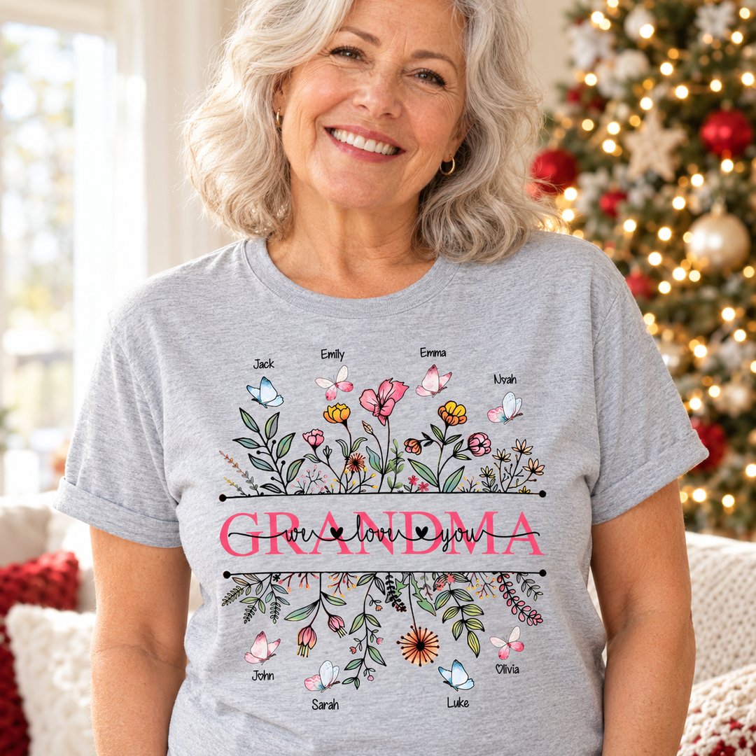 Grandma wearing personalized Wildflower Grandma We Love You t-shirt in a bright holiday living room