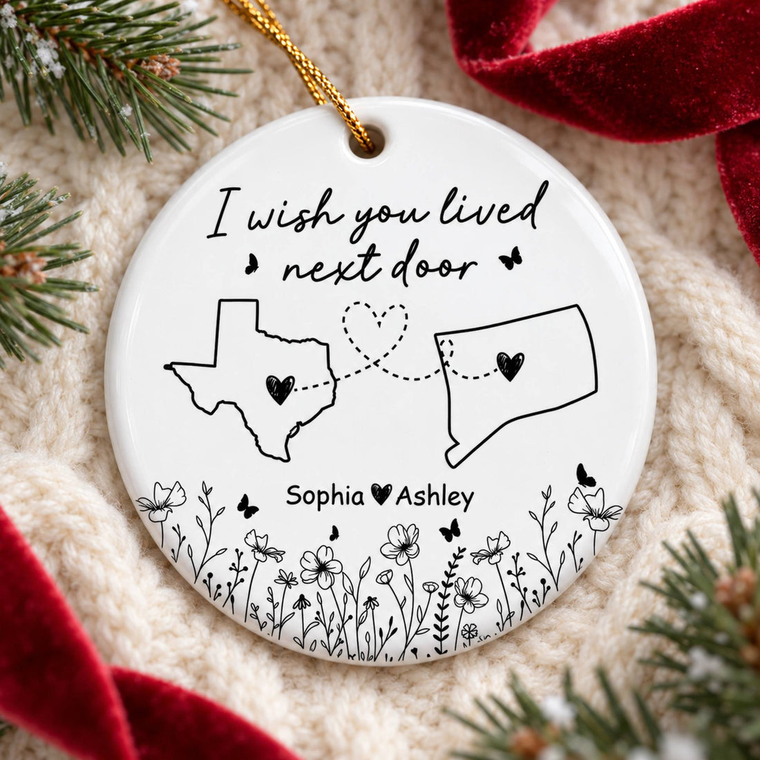 Long distance friendship circle ceramic ornament lying flat on a cozy cream knit blanket with pine sprigs