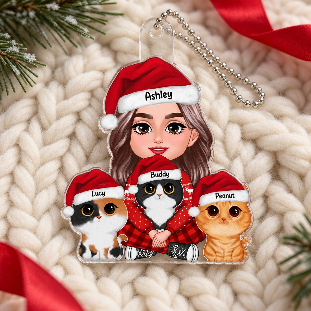 Personalized woman holding three cats acrylic ornament lying flat on a cream knit Christmas throw