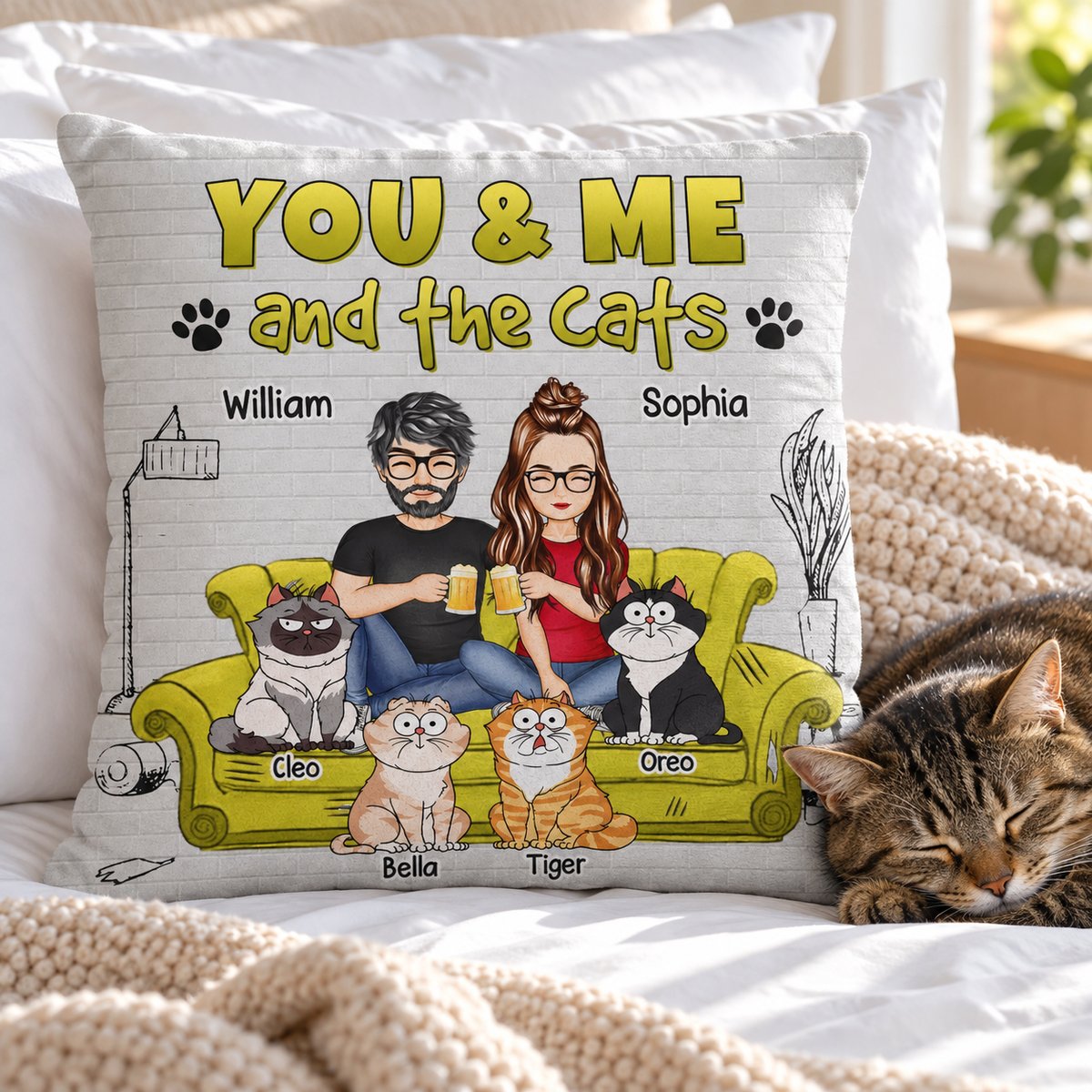 Personalized cat lover couple throw pillow styled on a bright cozy bed next to a napping cat