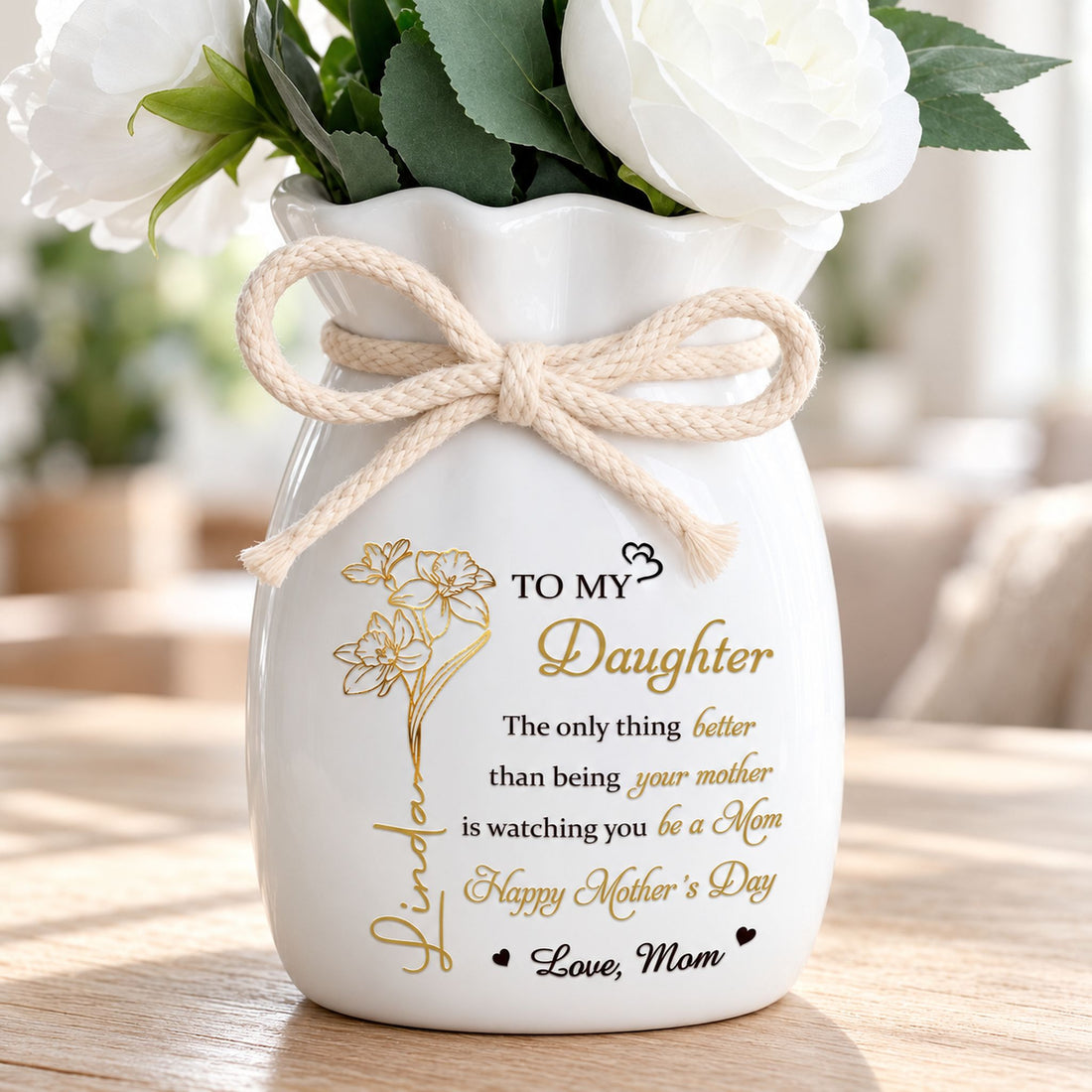 Close-up of personalized flower vase showing braided rope bow and gold floral name print