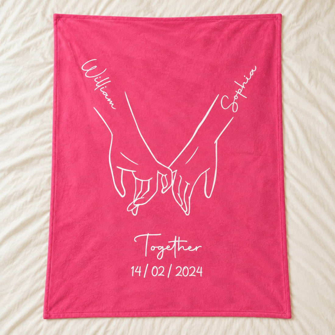 Personalized couple fleece blanket with holding hands print spread flat on a cream bed