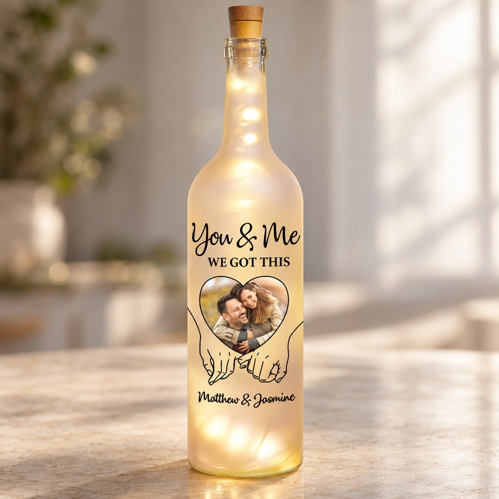 Close-up detail of frosted glass print and interlocking hands on personalized bottle light