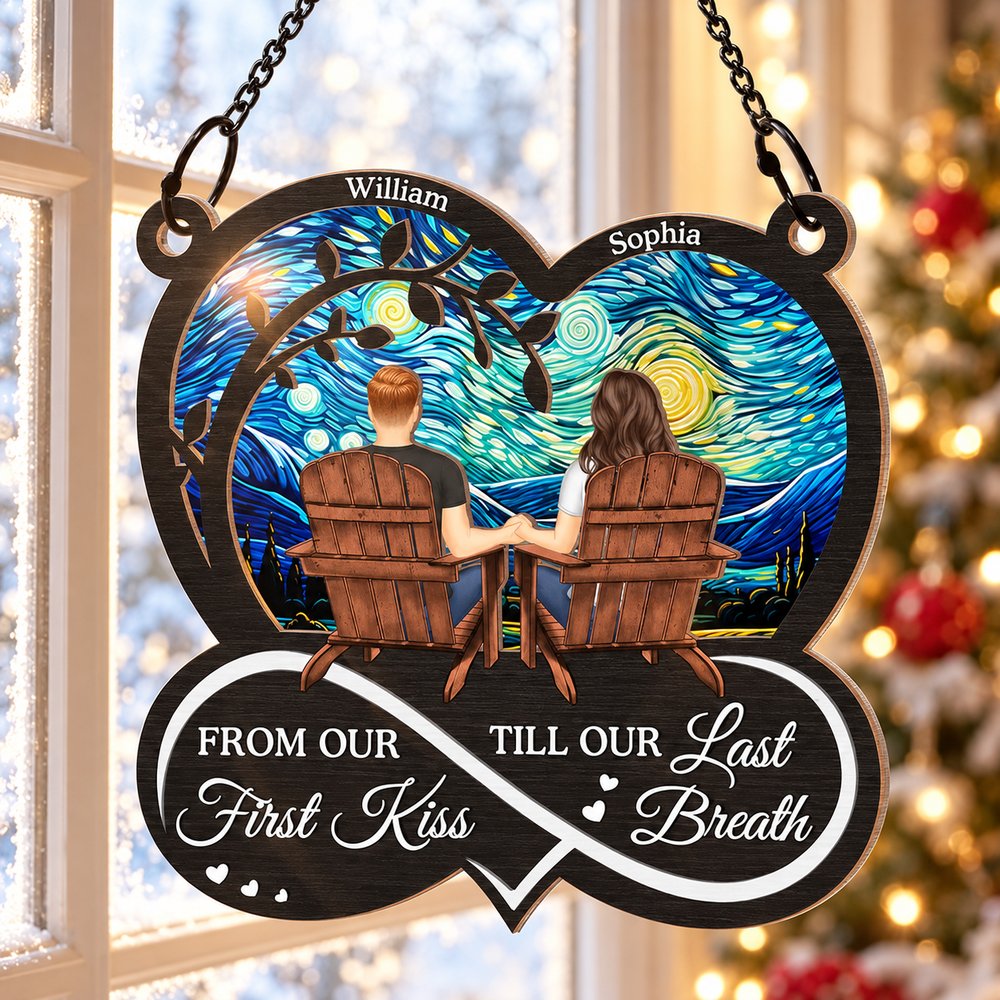 Couple suncatcher ornament hanging near a cozy holiday window with Christmas tree lights