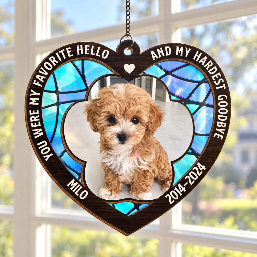 Personalized pet memorial suncatcher ornament hanging in a bright sunlit window