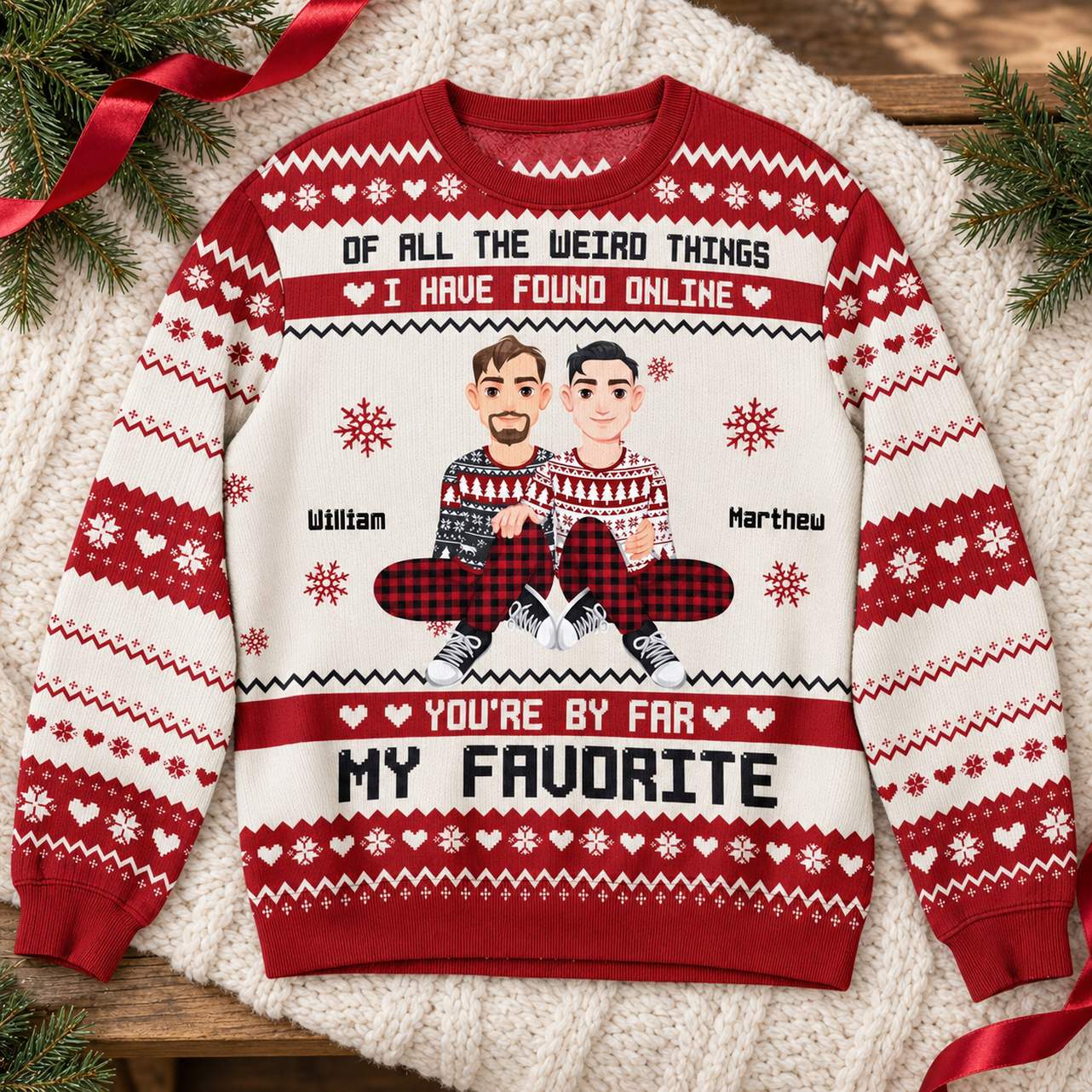 Personalized couple ugly Christmas sweater flat lay with holiday greenery