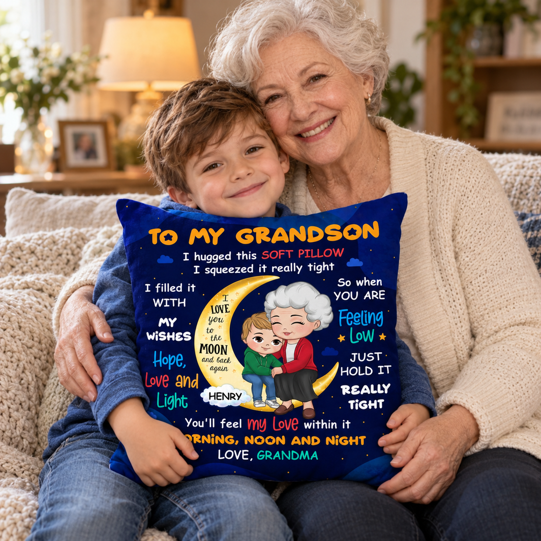 Grandmother and grandson hugging a personalized To My Grandson pillow on a sofa