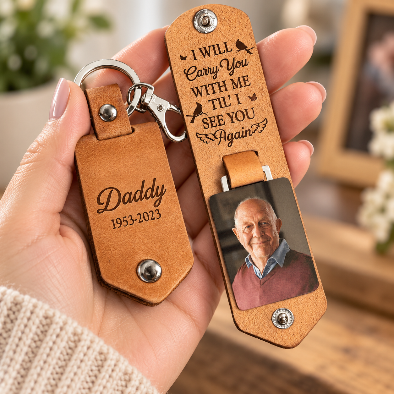 Woman holding a personalized leather memorial photo keychain with name Daddy