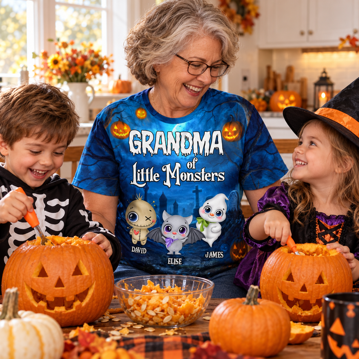 Grandma in a Little Monsters Halloween t-shirt carving pumpkins with two grandkids in costumes