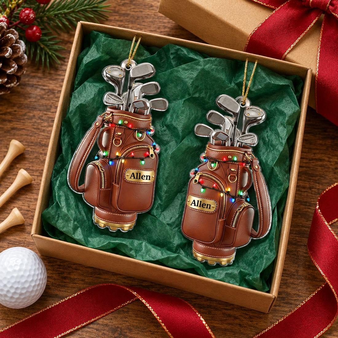 Two custom name golf bag acrylic ornaments in a gift box with green tissue and golf tees