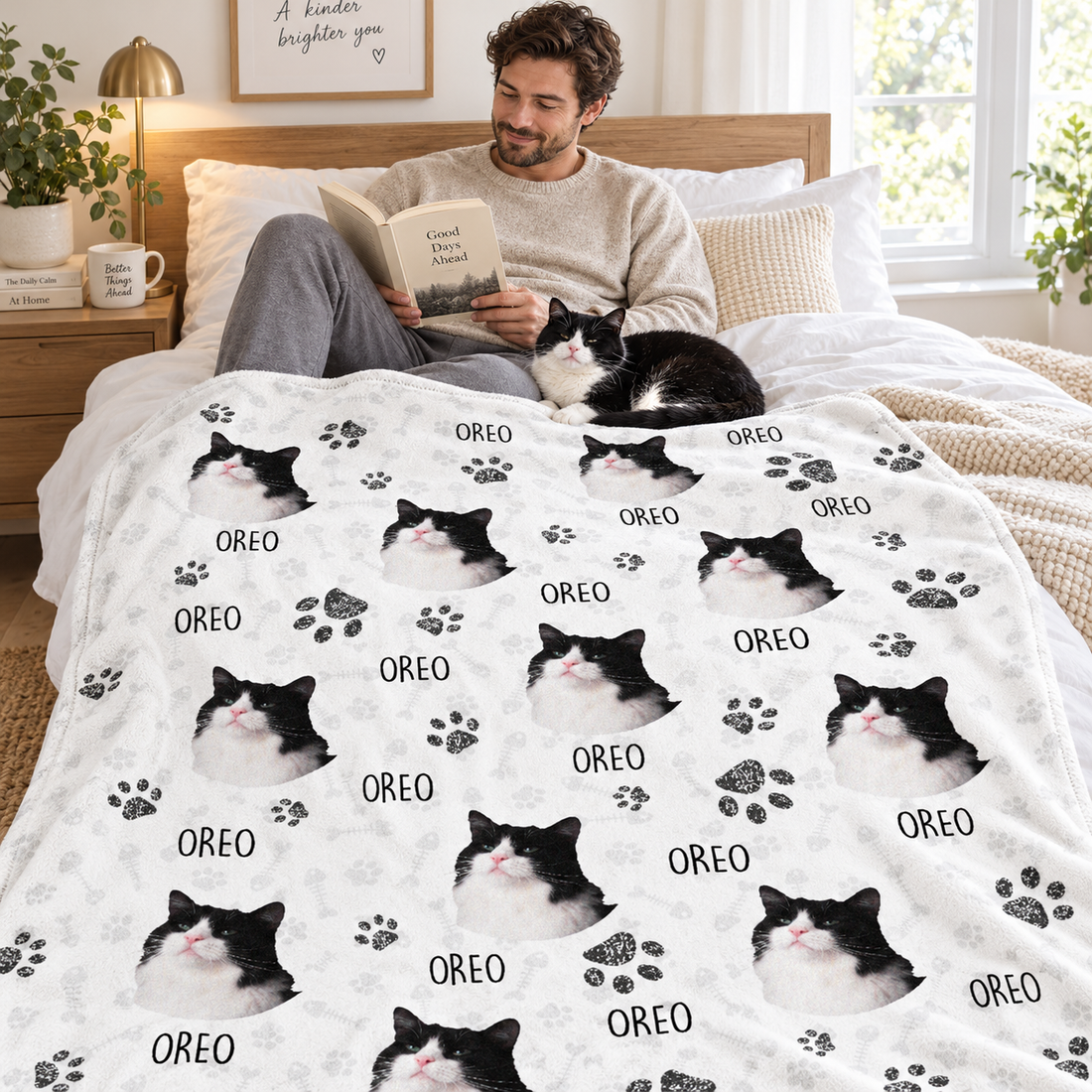 Man reading in bed with his cat on a custom pet photo blanket printed with paw prints and name