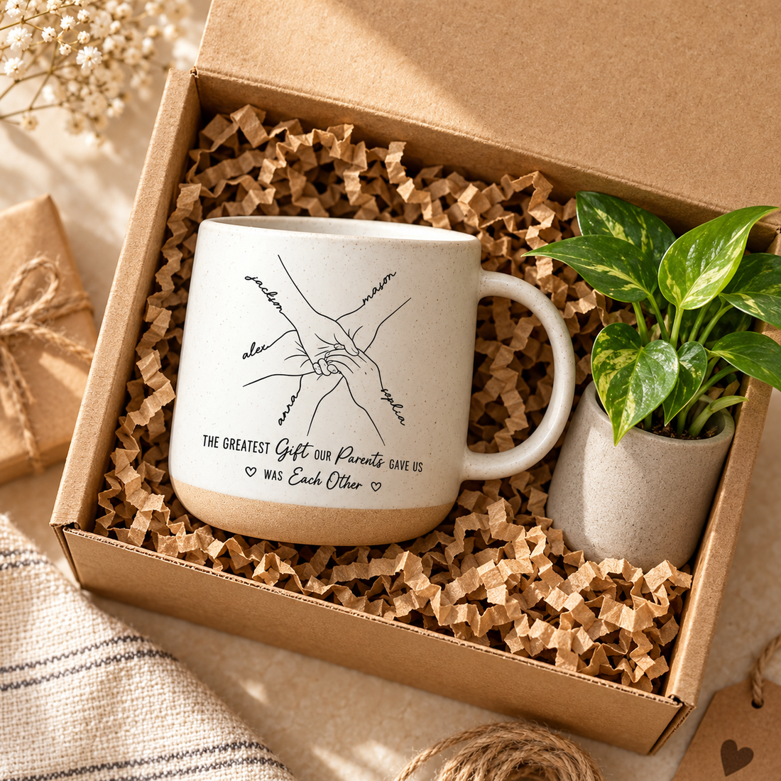 White pottery handprint line art mug in a gift box with kraft filler and a small plant