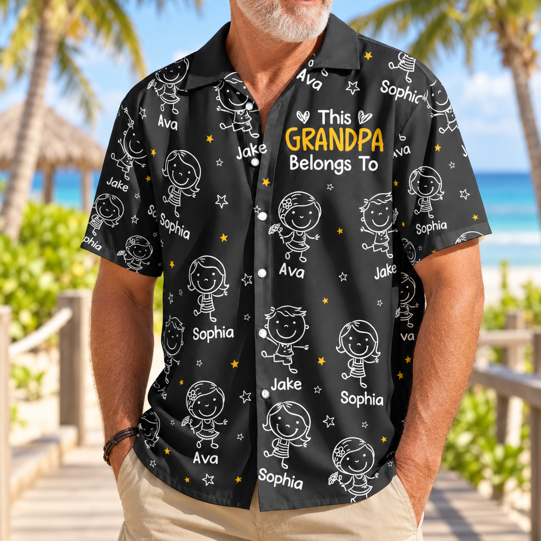 Man wearing a personalized This Grandpa Belongs To doodle Hawaiian shirt on a tropical boardwalk