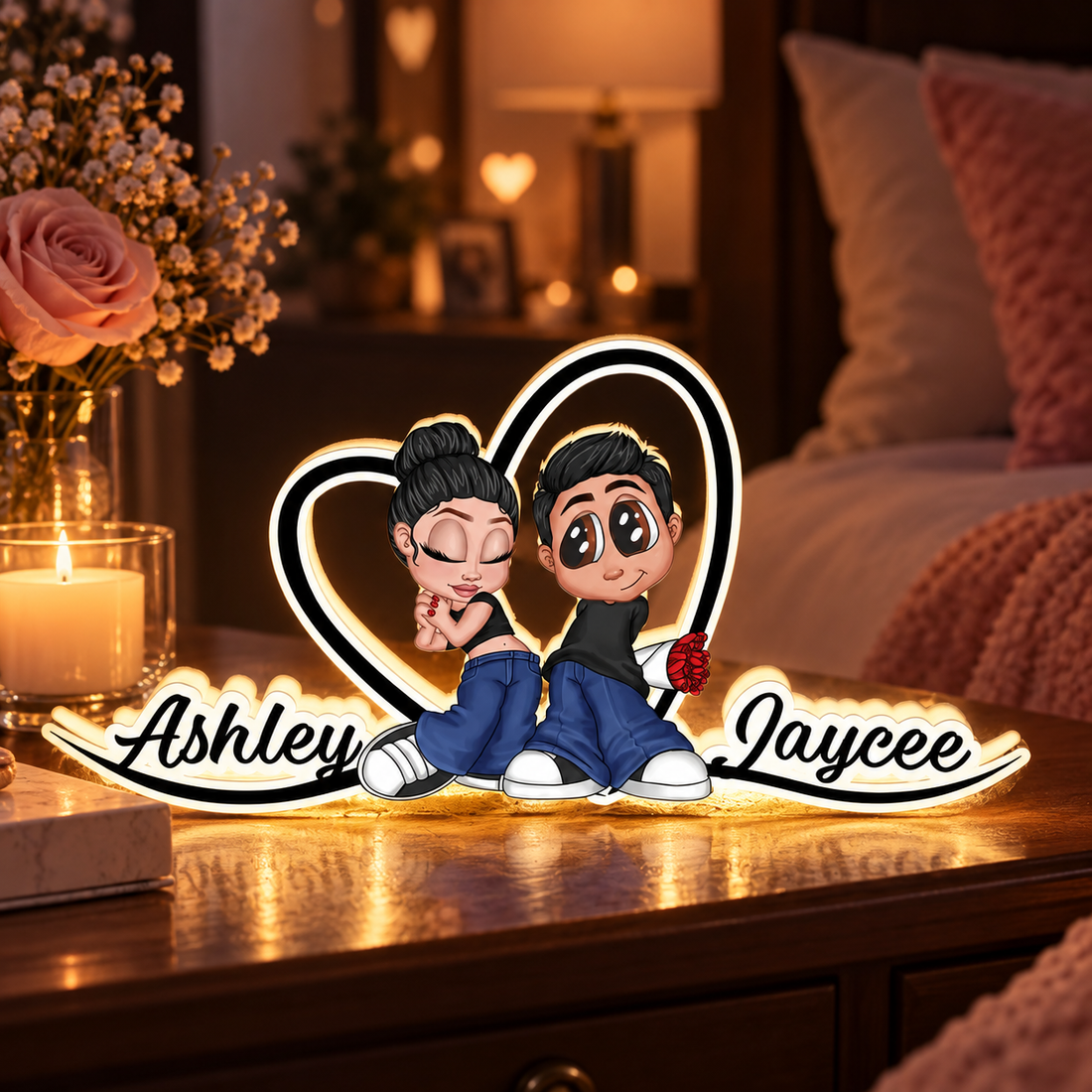 Heart-shaped couple acrylic light box with names glowing on a bedside table in a romantic bedroom