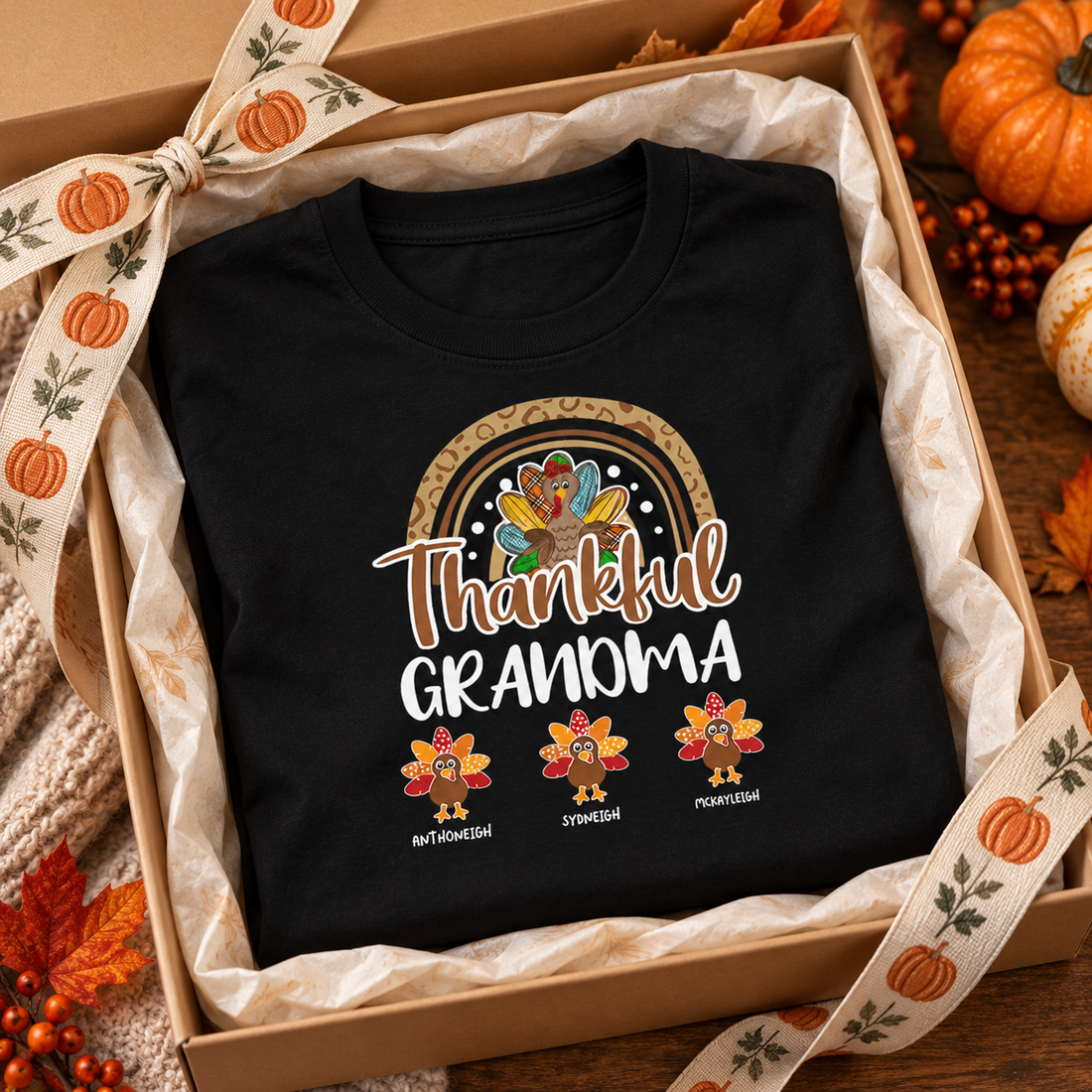 Personalized Thankful Grandma t-shirt folded in a gift box with tissue, ribbon and mini pumpkins