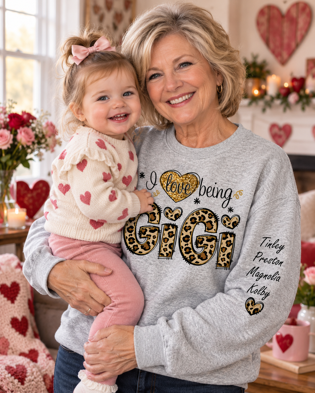 Personalized I Love Being GiGi leopard sweater worn by a grandmother holding a toddler