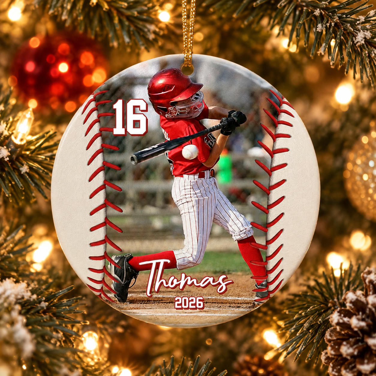 Personalized baseball player ceramic ornament number 16 with name Thomas on a Christmas tree
