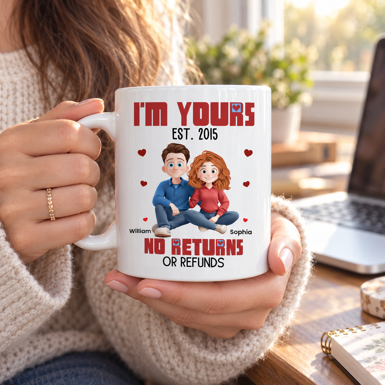 Woman holding a personalized I'm Yours cartoon couple mug by a sunny window