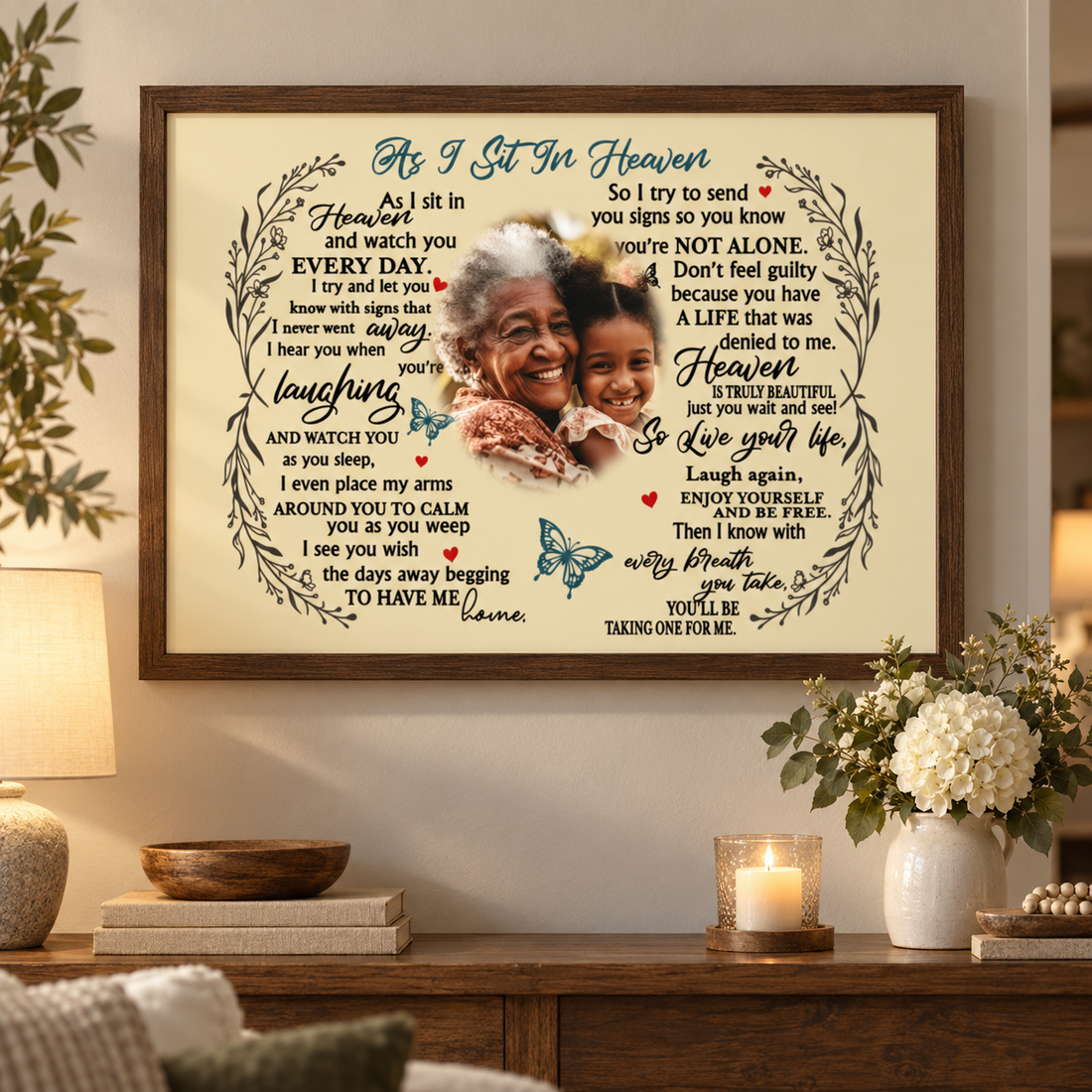 As I Sit In Heaven memorial poster with family photo hung above a console table with candle