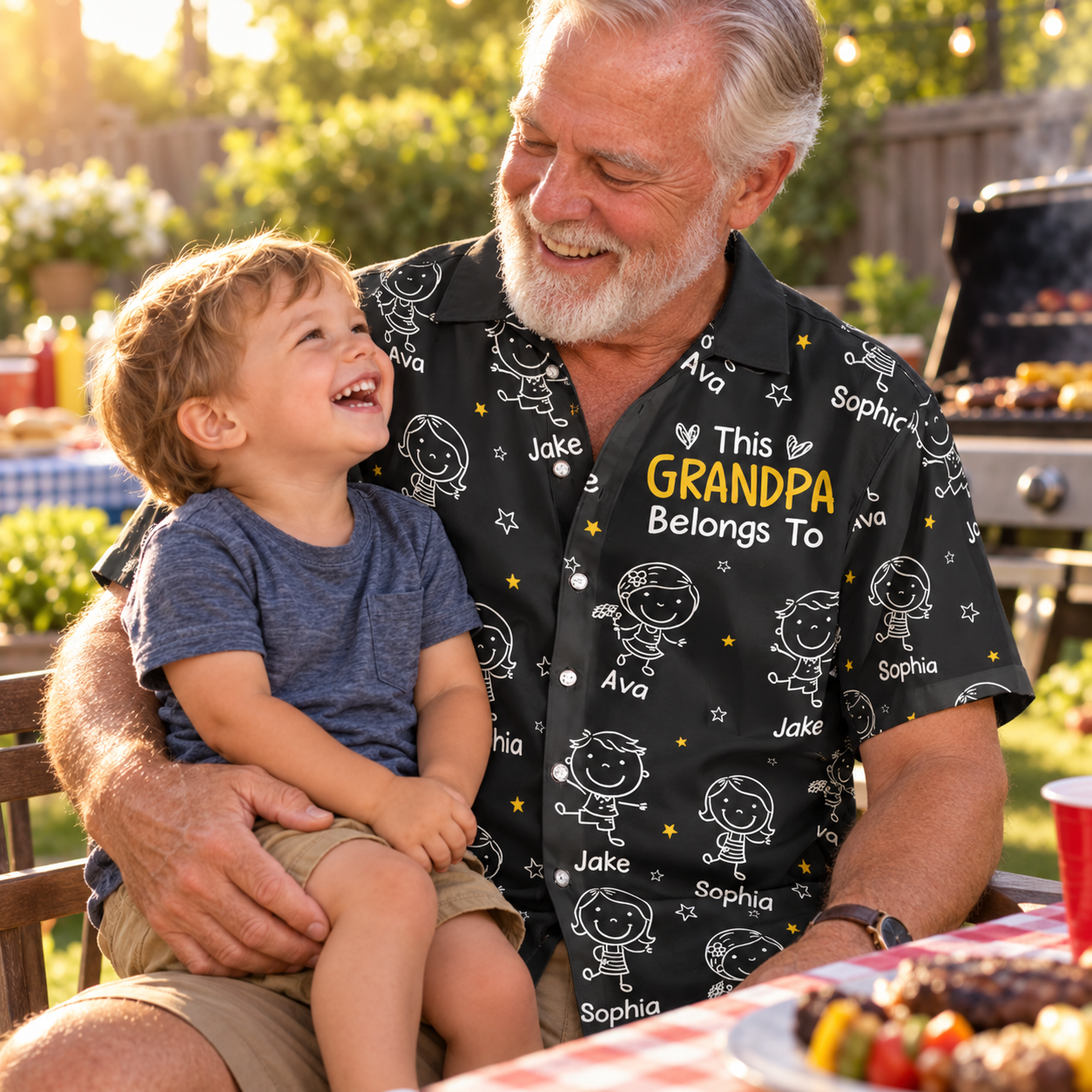 Grandpa holding grandson on his lap at a barbecue wearing a personalized doodle Hawaiian shirt