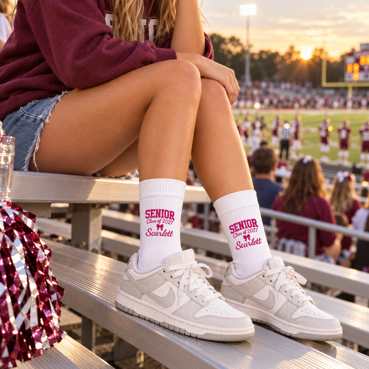 Girl wearing personalized Senior embroidered socks on football stadium bleachers