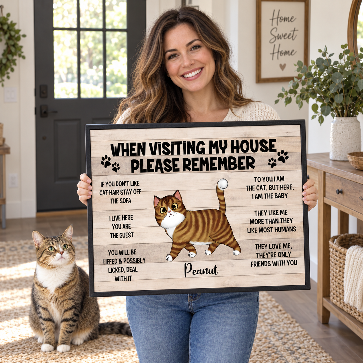 Woman holding a personalized When Visiting My House Please Remember cat canvas print at home