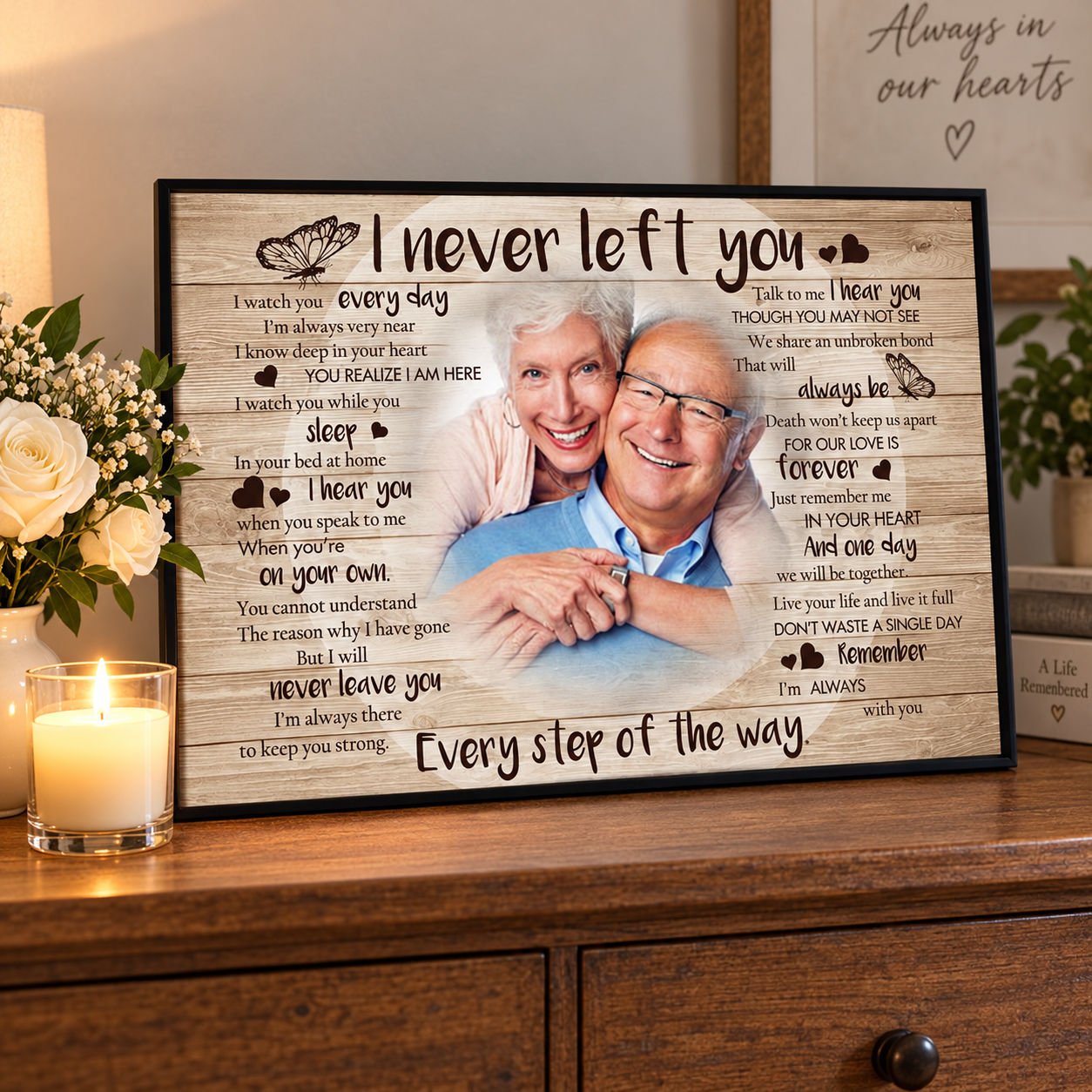 Custom I Never Left You memorial couple photo poster on a dresser with a lit candle and white roses