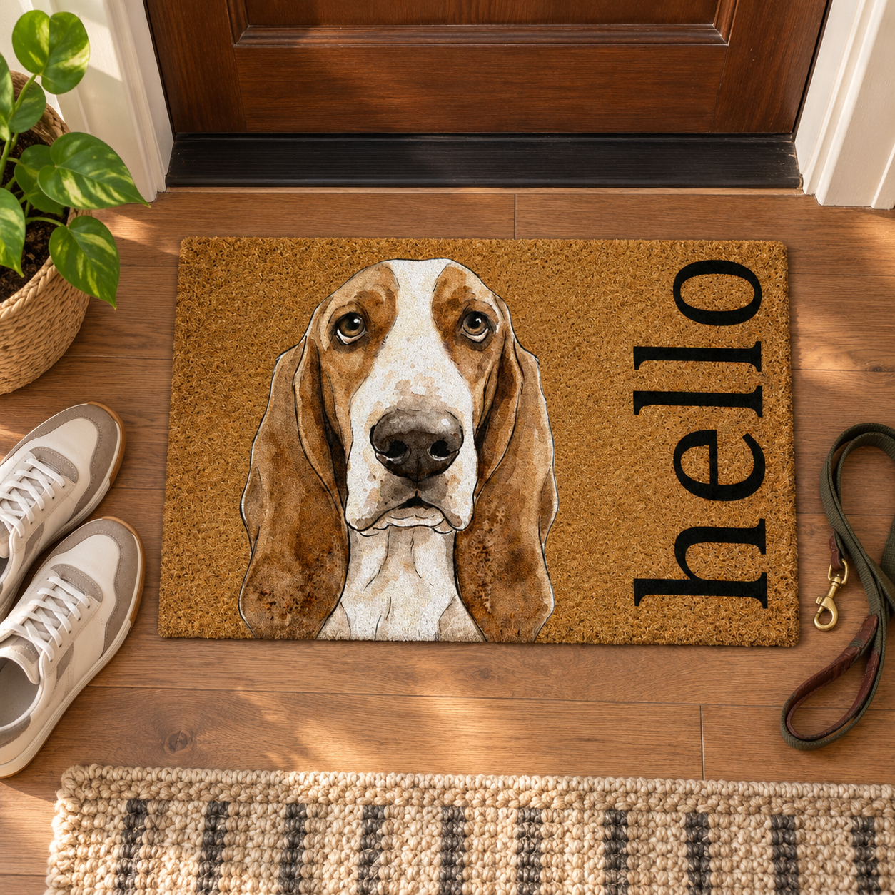 Top view of a personalized pet Hello doormat in an entryway beside shoes and a leash