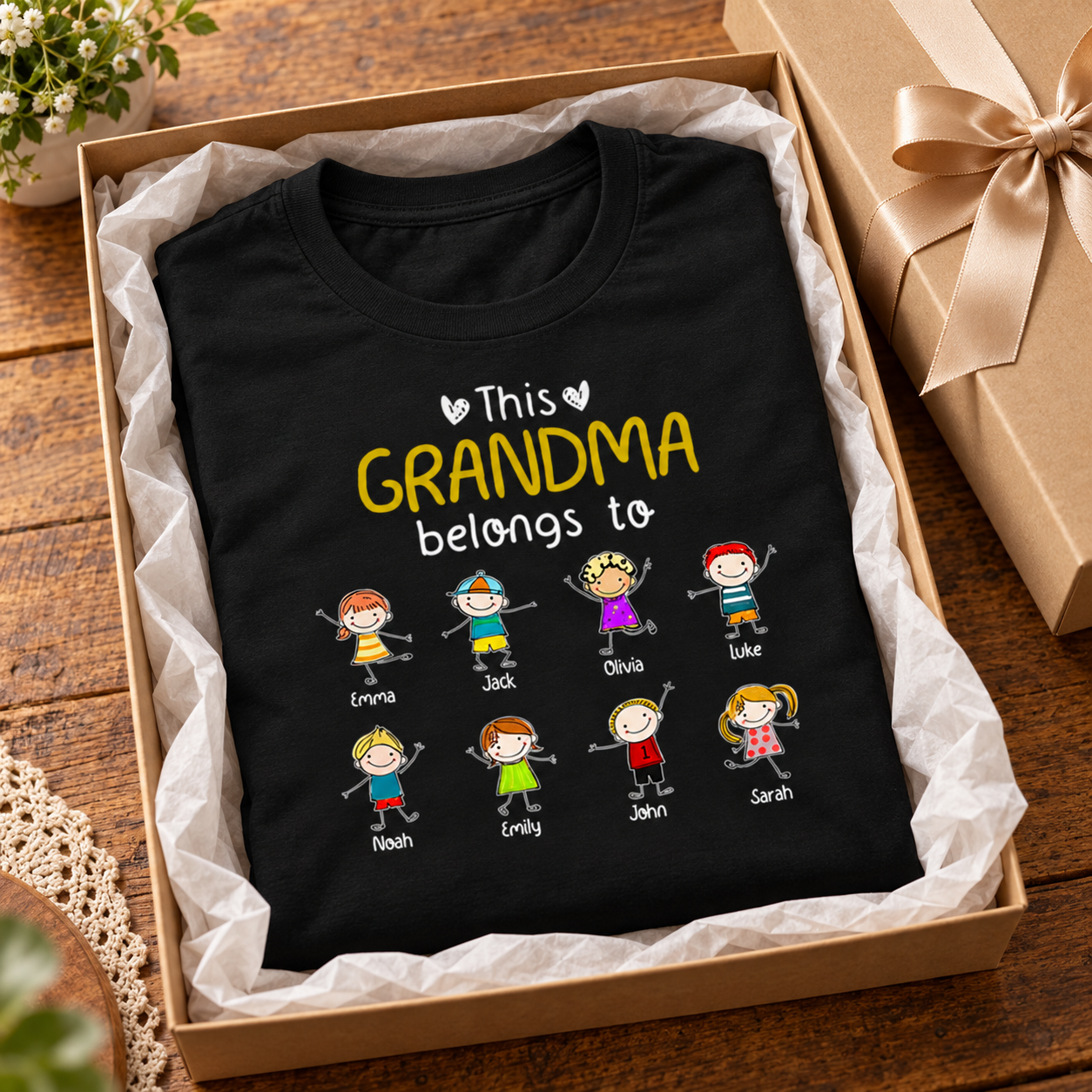 Personalized Grandma Grandpa Belongs To t-shirt folded in a gift box with tissue paper and ribbon