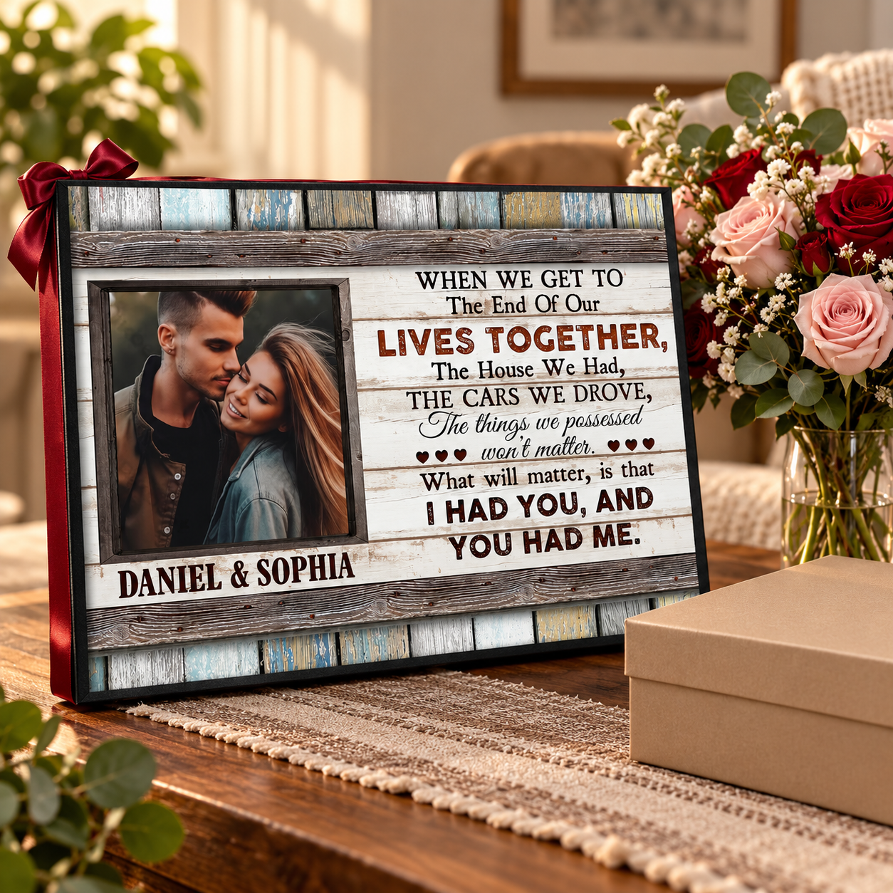 Custom couple canvas print wrapped with a ribbon as a gift beside flowers on a table