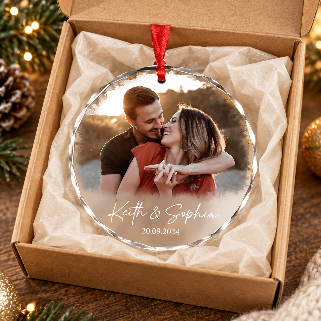 Custom round crystal glass couple photo ornament in a kraft gift box with a red ribbon