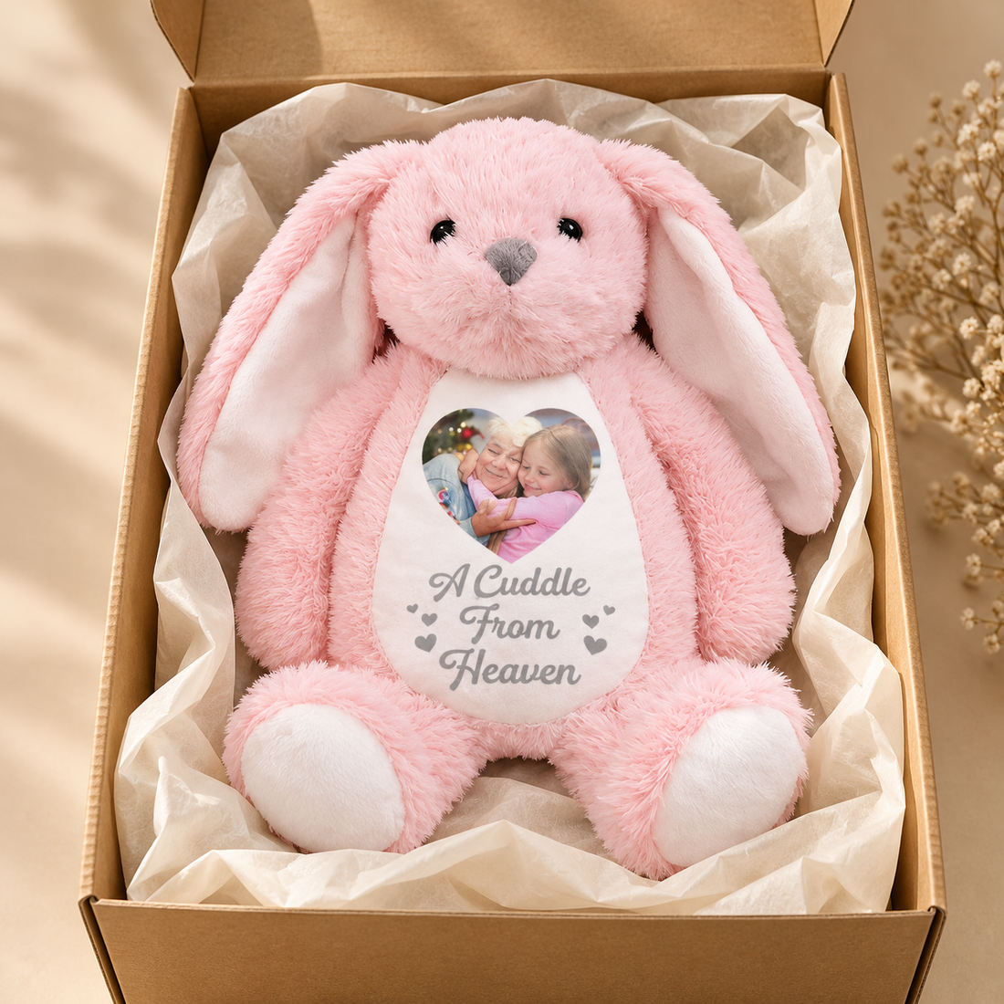 Custom memorial plush bunny with heart photo in an open kraft gift box with tissue paper