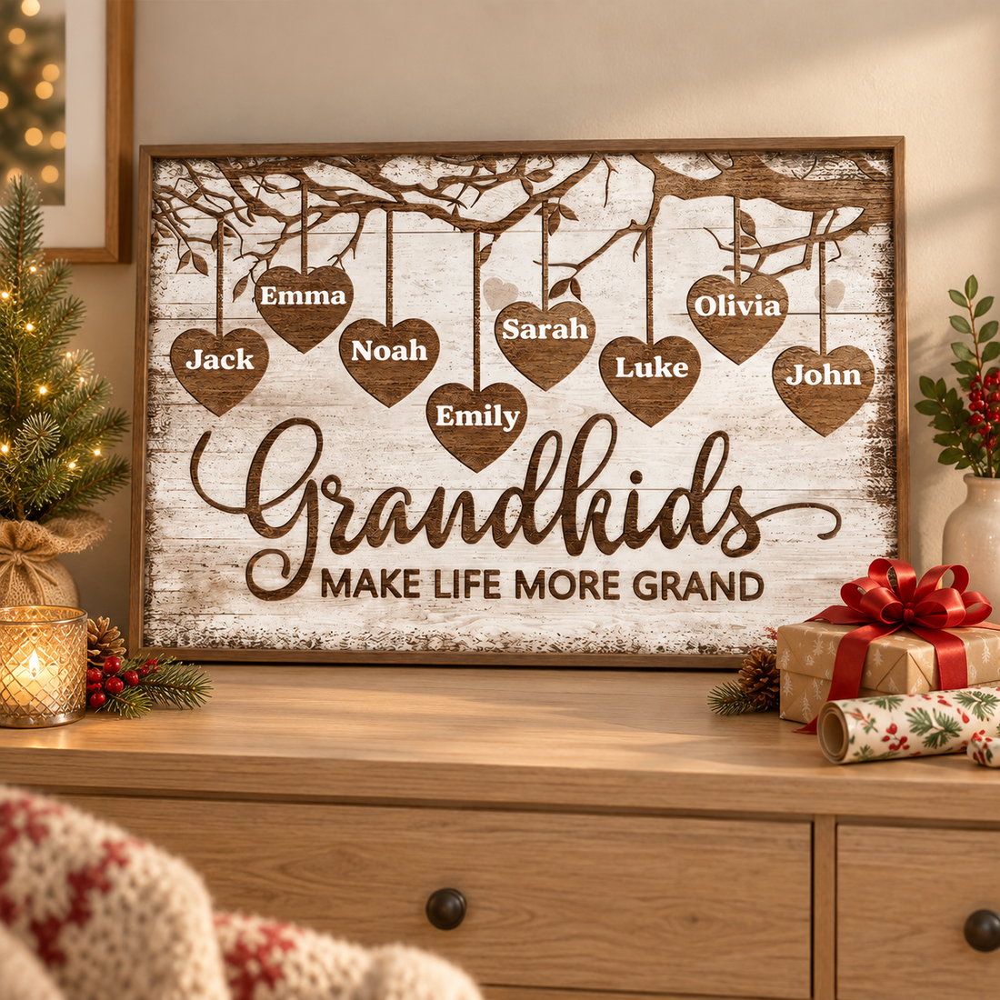 Custom Grandkids Make Life More Grand wood heart names poster on a dresser beside a Christmas gift and wrapping paper