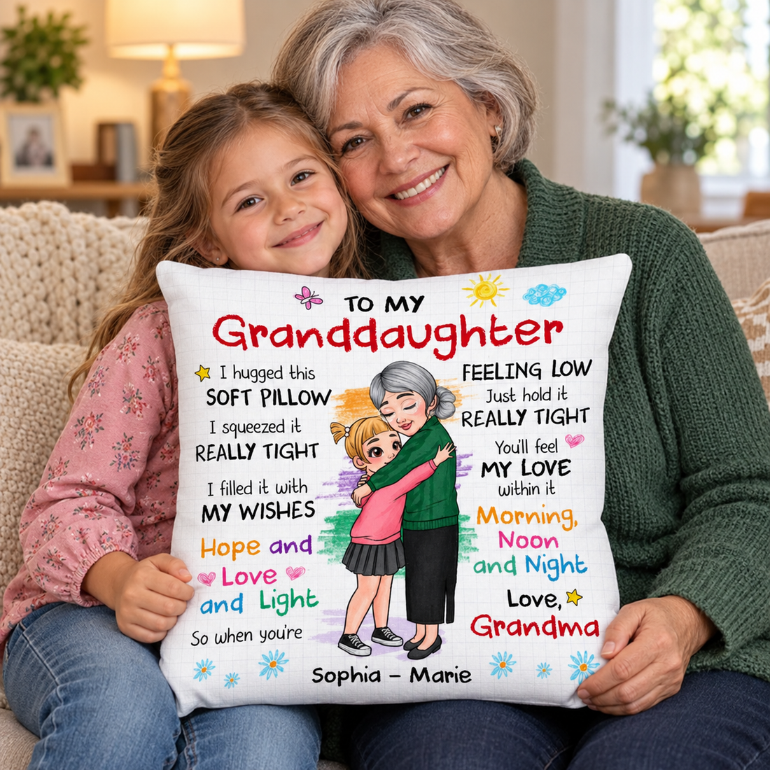 Grandma and granddaughter holding a To My Granddaughter personalized hug pillow on a sofa