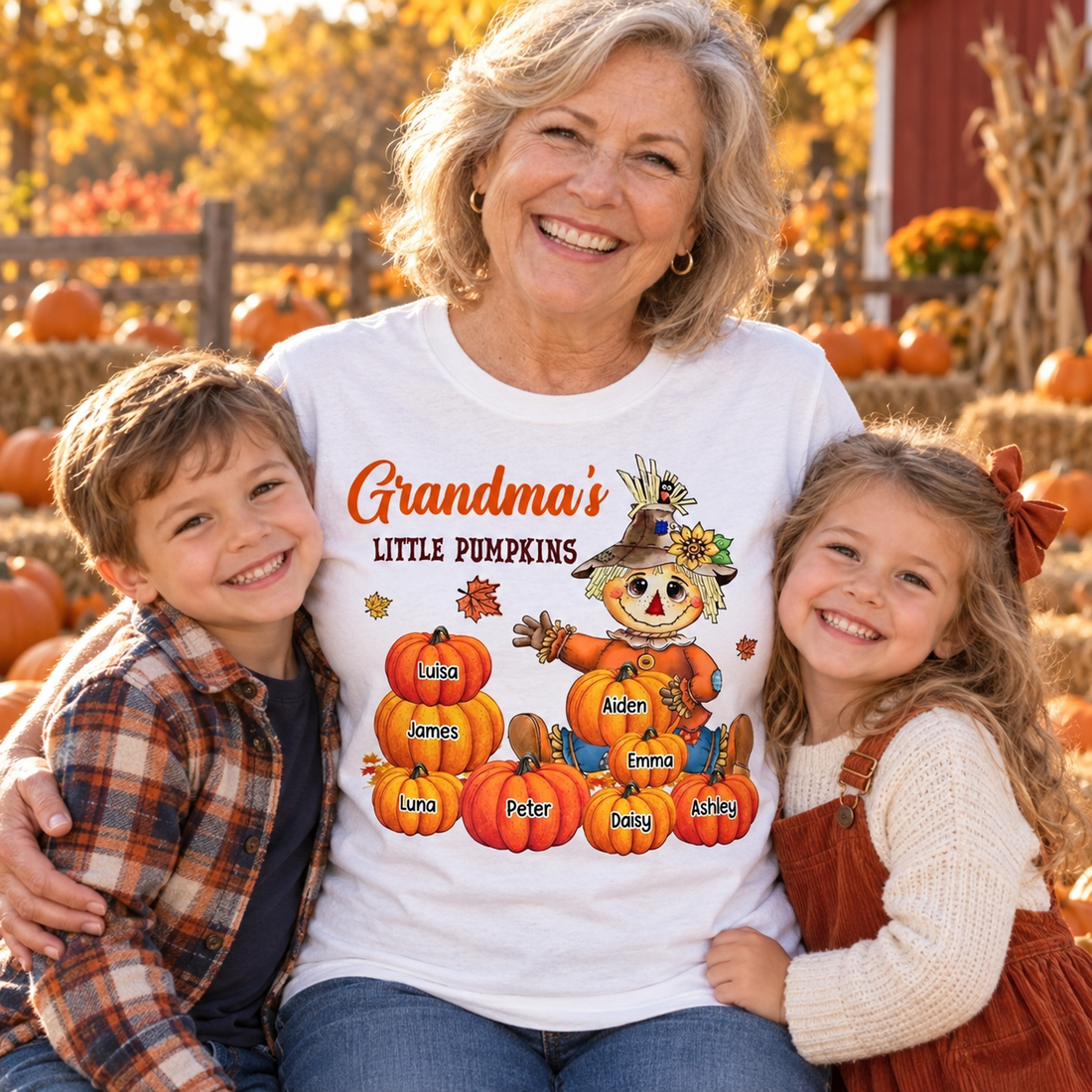 Grandma in a white Grandma's Little Pumpkins scarecrow t-shirt with two grandkids in a pumpkin patch