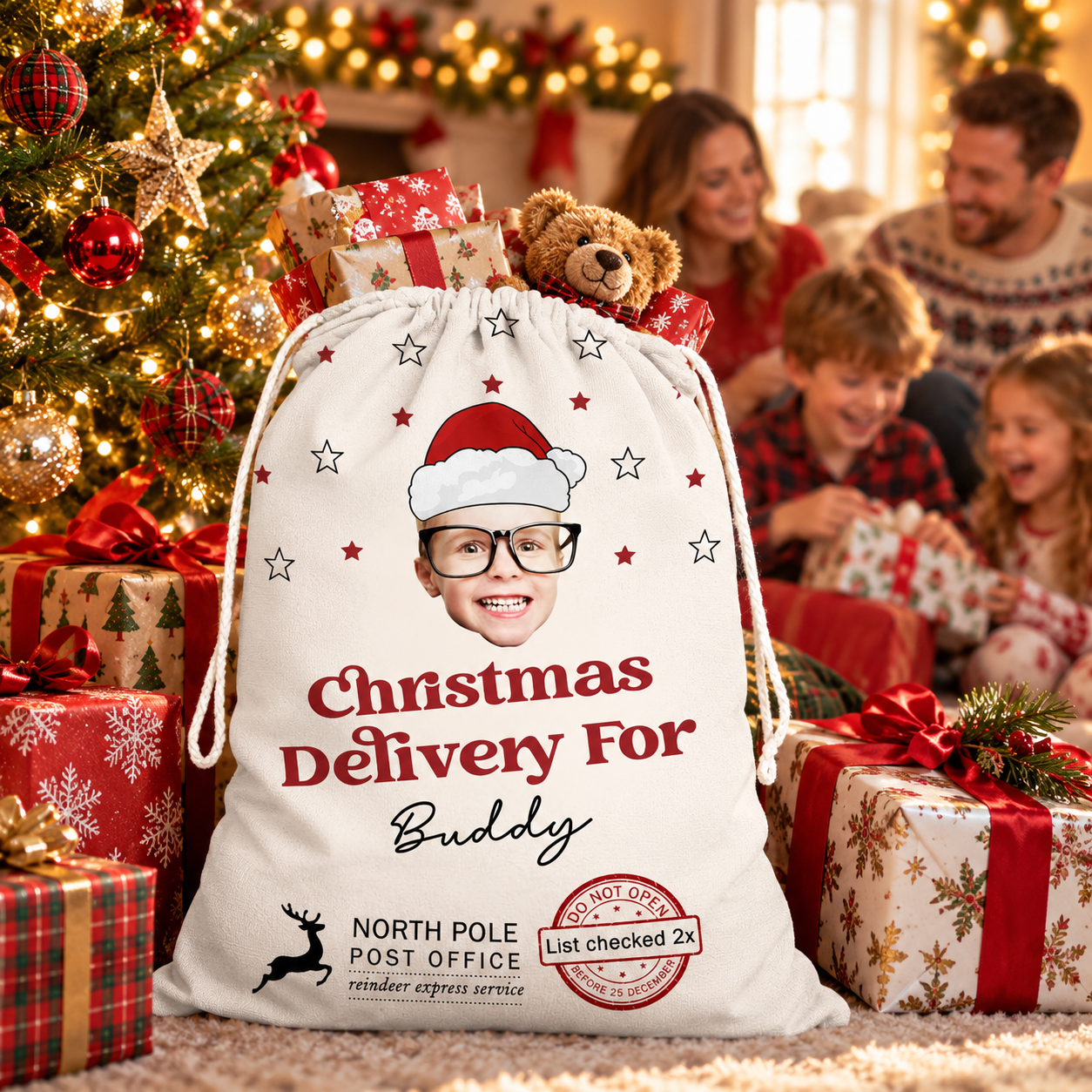 Personalized Santa sack beside a decorated Christmas tree with gifts spilling out and a family behind