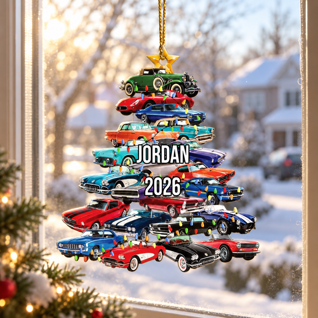 Custom stacked classic cars Christmas tree ornament with name Jordan hanging in a sunny window with snow outside