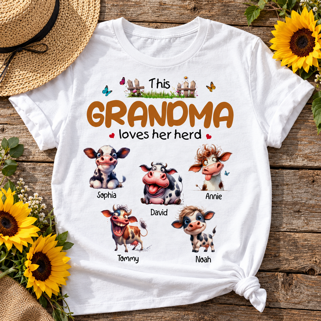 Personalized This Grandma Loves Her Herd cow t-shirt flat lay with straw hat and sunflowers