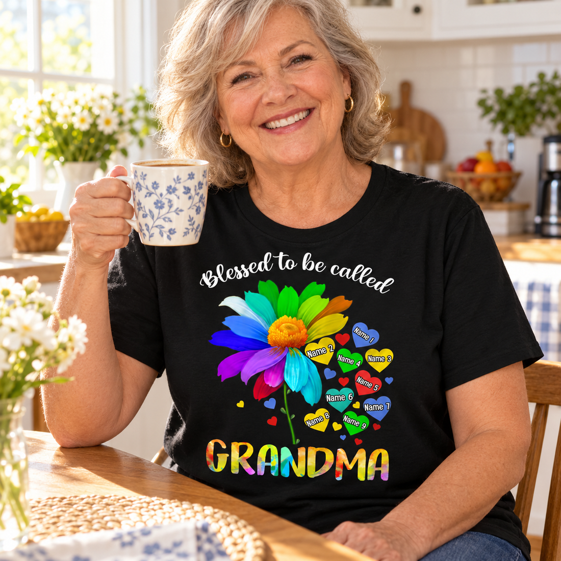 Happy grandma in a personalized Blessed To Be Called Grandma t-shirt having coffee in the kitchen