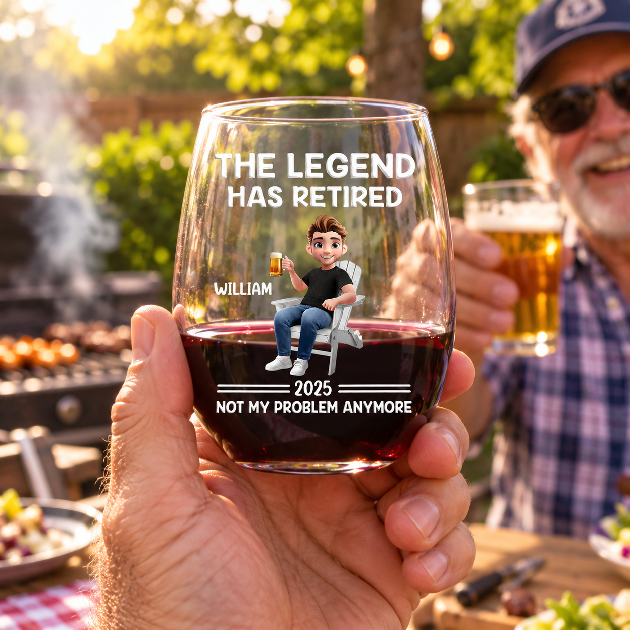 Friends clinking The Legend Has Retired personalized wine glasses at a backyard BBQ